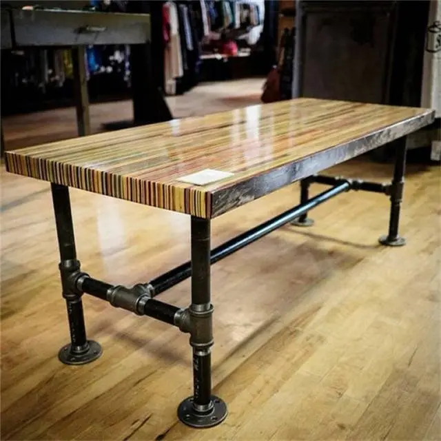 The assembled black pipe legs of a DIY industrial chic workbench